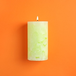 Photo of Alight scented wax candle on color background