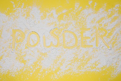Photo of Word Powder made of baby cosmetic product on yellow background, top view