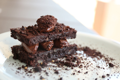 Photo of Delicious chocolate brownie dessert on plate, closeup view