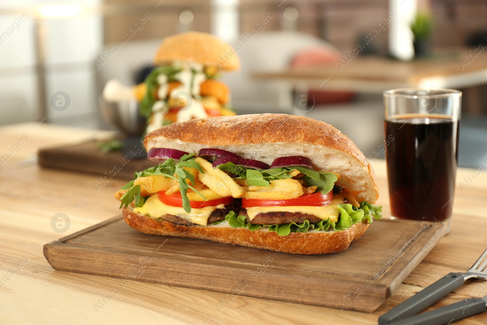 Photo of Wooden serving plate with yummy sandwich on table in cafe