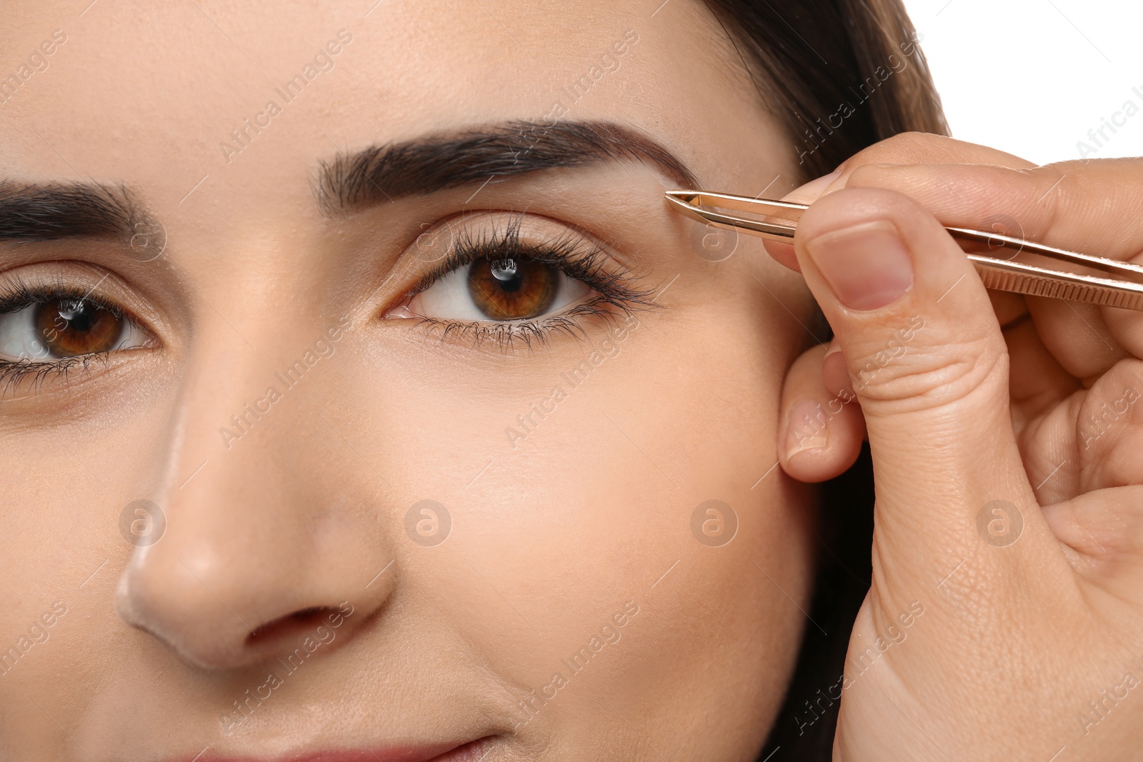 Photo of Young woman having professional eyebrow correction procedure, closeup