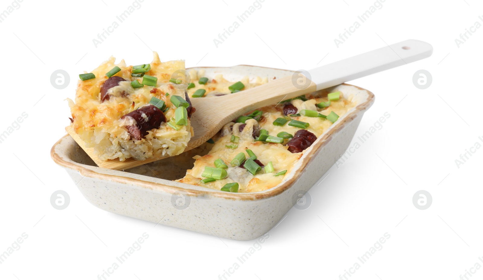 Photo of Taking piece of tasty sausage casserole with green onion from baking dish isolated on white