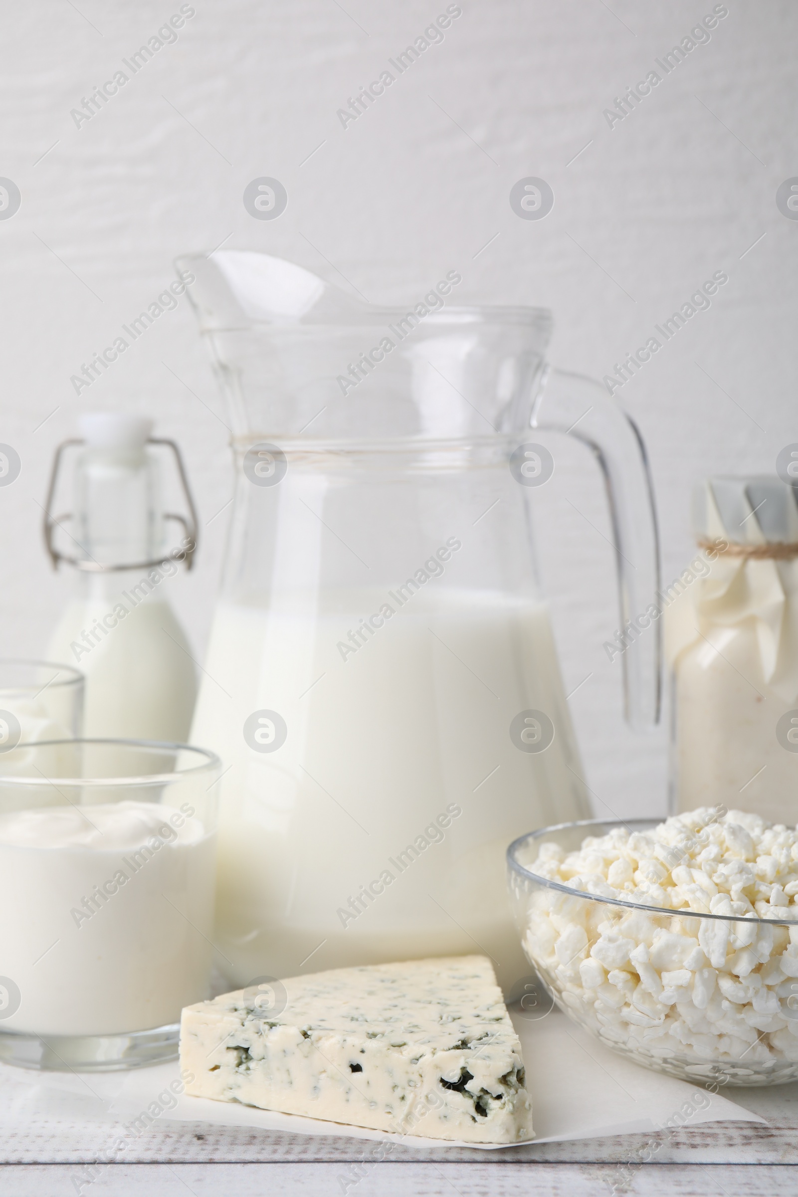 Photo of Different fresh dairy products on white wooden table