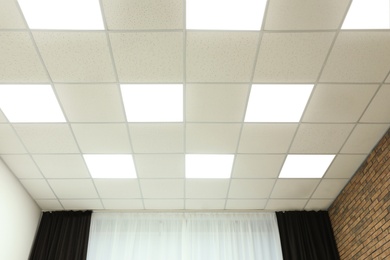 Photo of White ceiling with lighting in office room