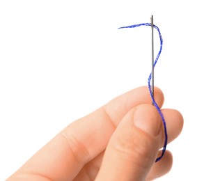 Woman holding sewing needle with thread on white background, closeup