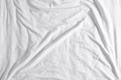 Photo of Crumpled white fabric as background, top view