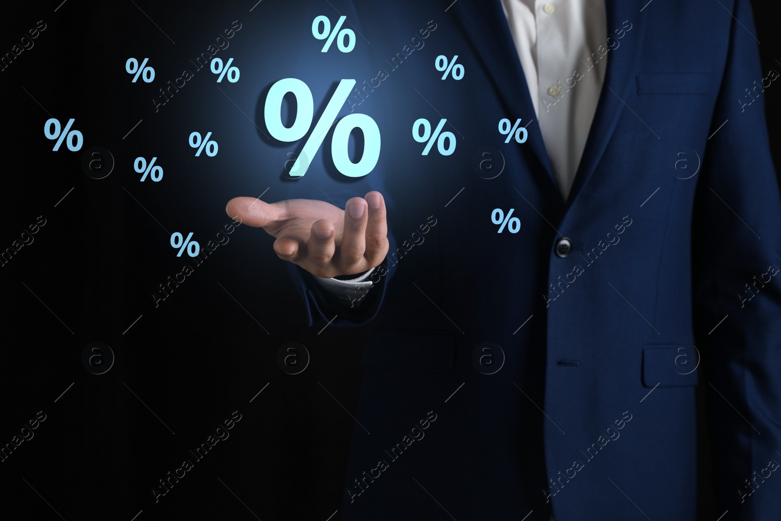 Image of Man showing virtual percent sign on black background, closeup. Discount concept