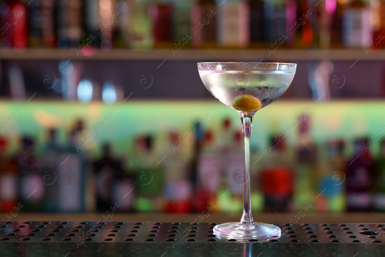 Photo of Fresh Martini cocktail on counter in bar. Space for text