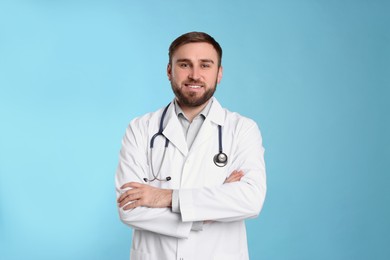 Photo of Pediatrician in uniform with stethoscope on light blue background