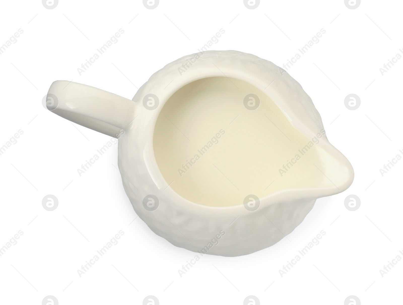 Photo of One jug full of fresh milk isolated on white, top view