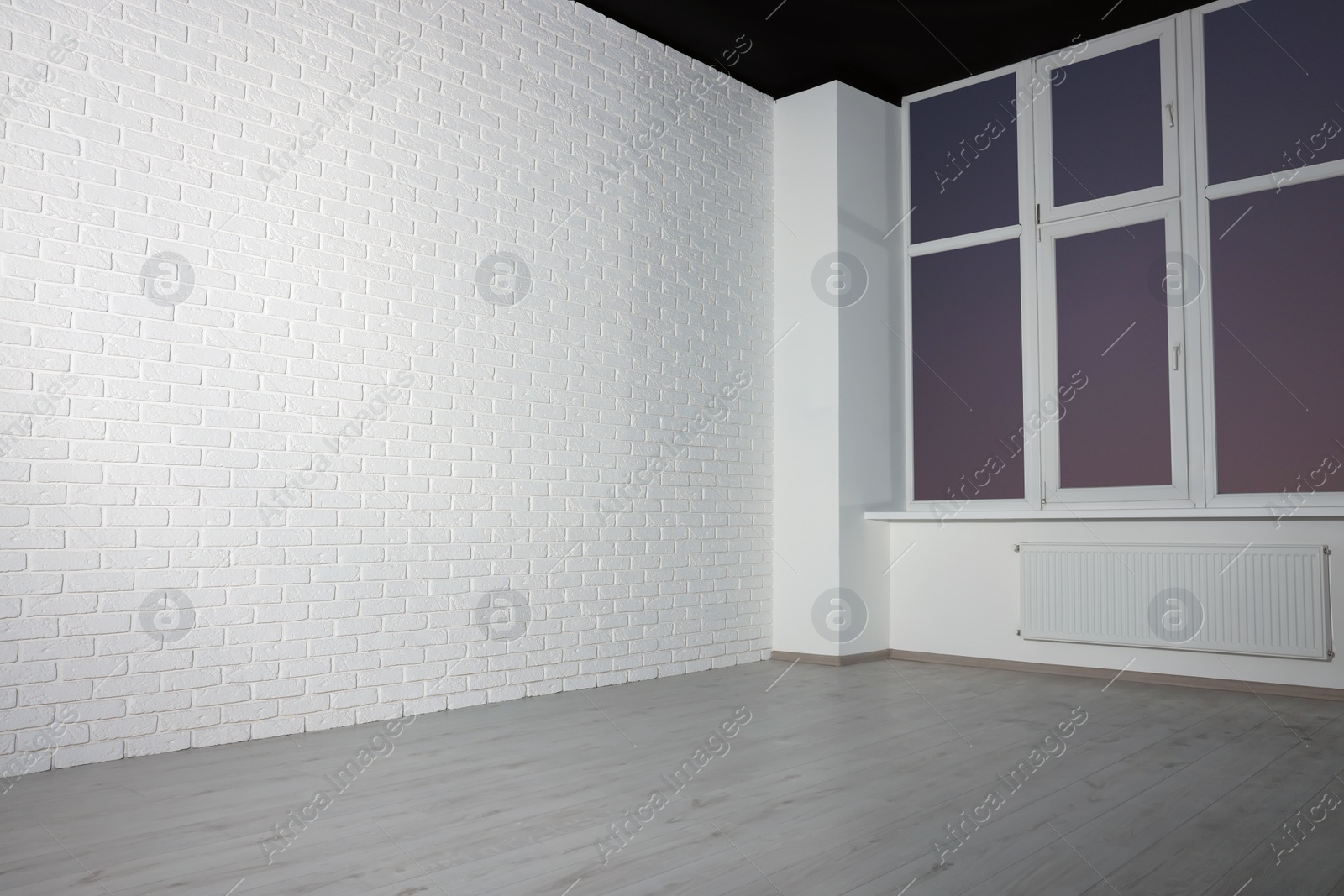 Photo of New empty room with clean windows and white walls