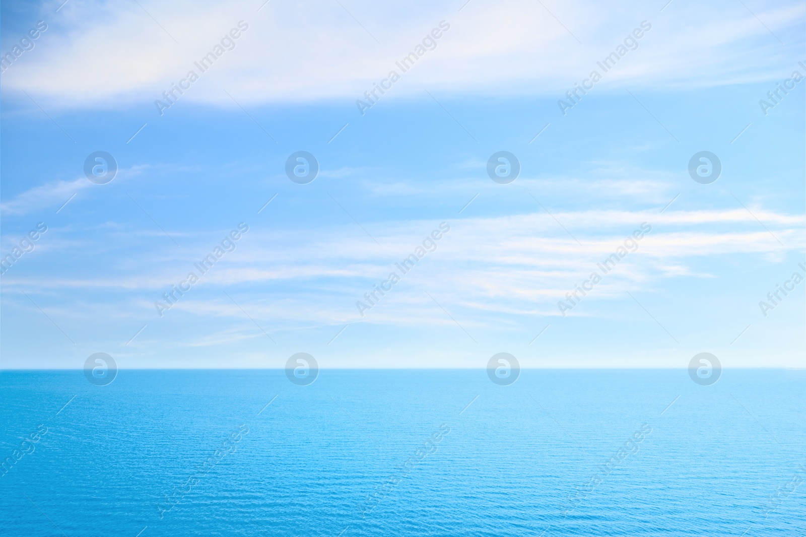 Image of Beautiful ripply sea under blue sky with clouds