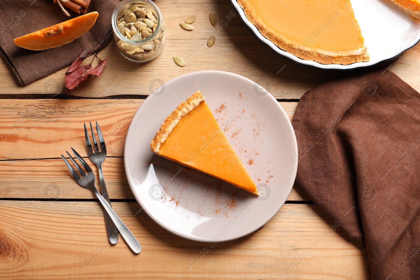 Photo of Flat lay composition with piece of fresh delicious homemade pumpkin pie on wooden background