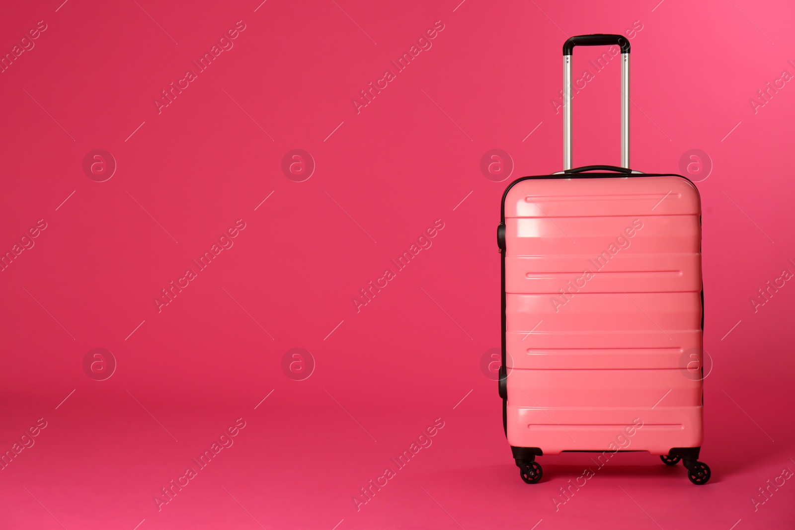 Photo of Stylish suitcase on color background. Space for text