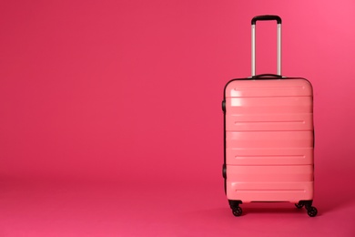 Photo of Stylish suitcase on color background. Space for text