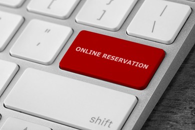 Red button with text Online Reservation on keyboard, closeup view