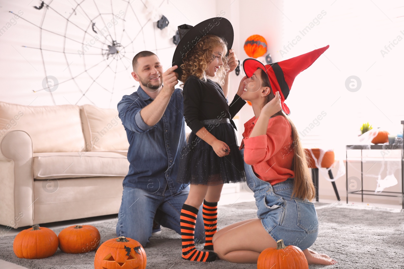 Photo of Happy family getting ready for Halloween party at home