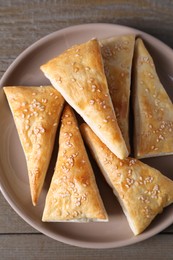 Photo of Delicious fresh puff pastries on wooden table, top view