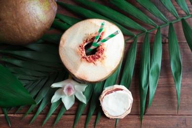 Photo of Beautiful composition with fresh green coconut on table, top view