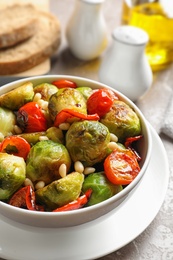 Photo of Bowl of salad with Brussels sprouts on table, closeup