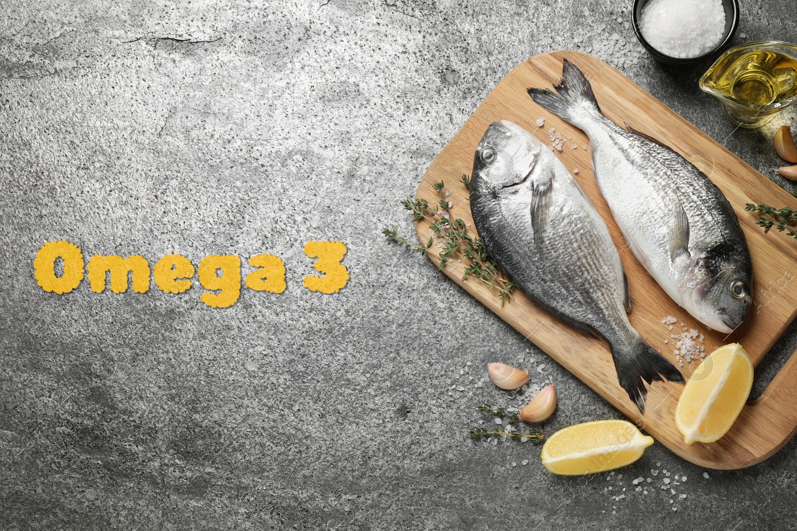 Image of Omega 3. Fresh dorado fish, oil, lemon and spices on grey table, flat lay