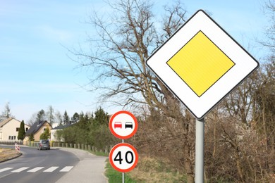 Photo of Different traffic signs on city street, space for text