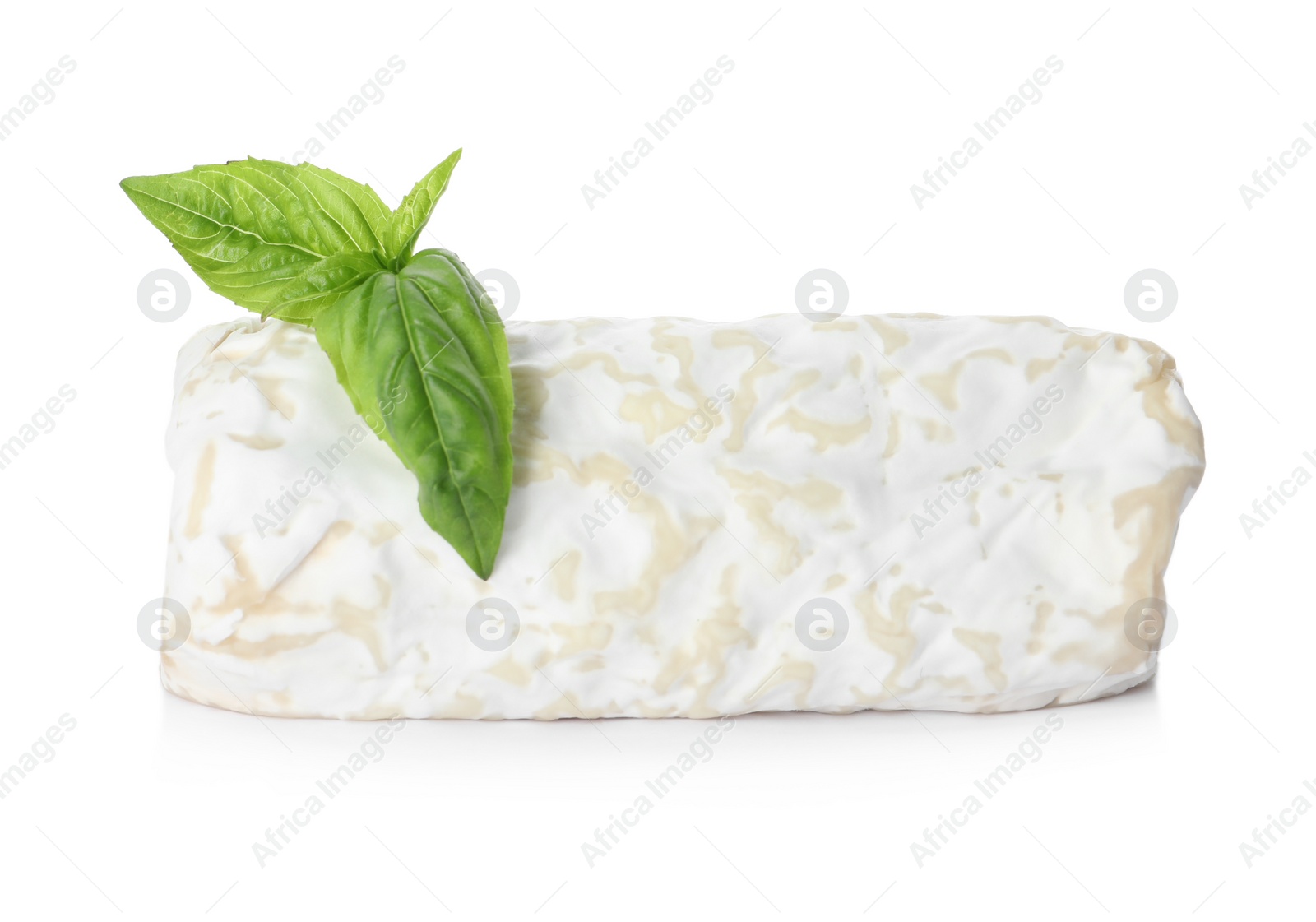 Photo of Delicious fresh goat cheese with basil on white background