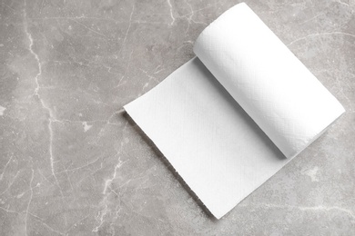 Roll of paper towels on marble table, top view