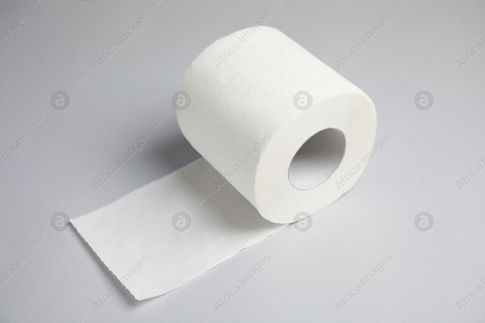 Photo of Toilet paper roll on grey background. Personal hygiene