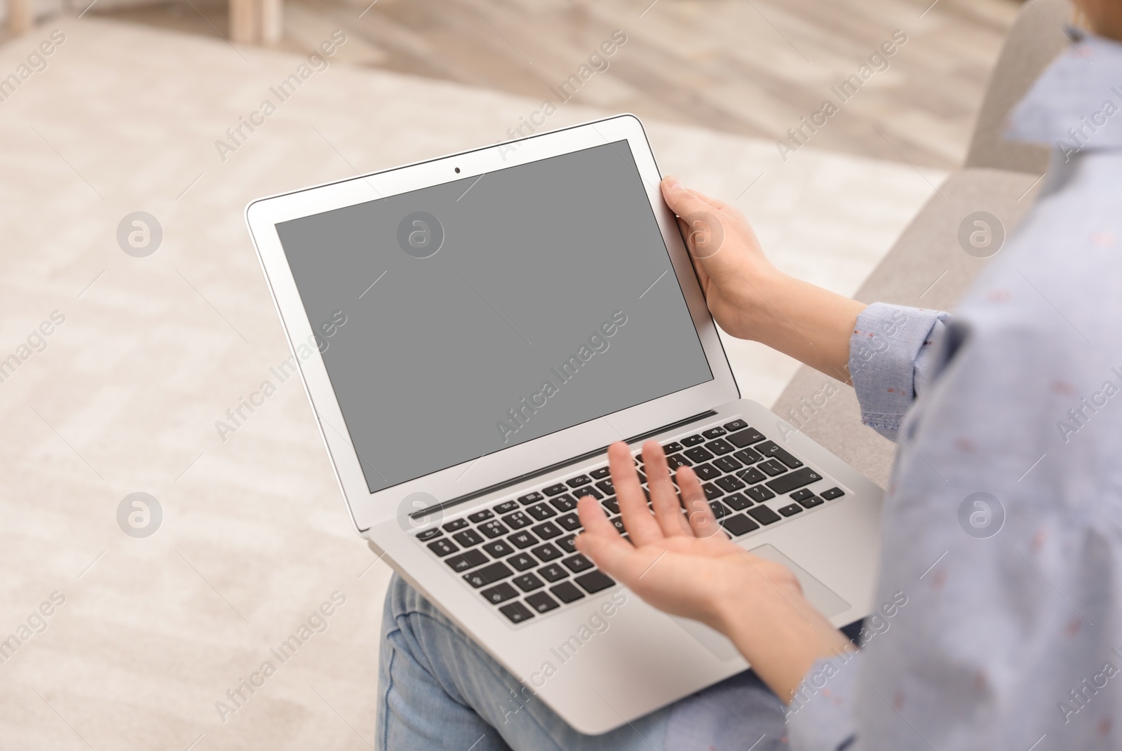 Photo of Young woman using video chat on laptop at home, closeup. Space for design