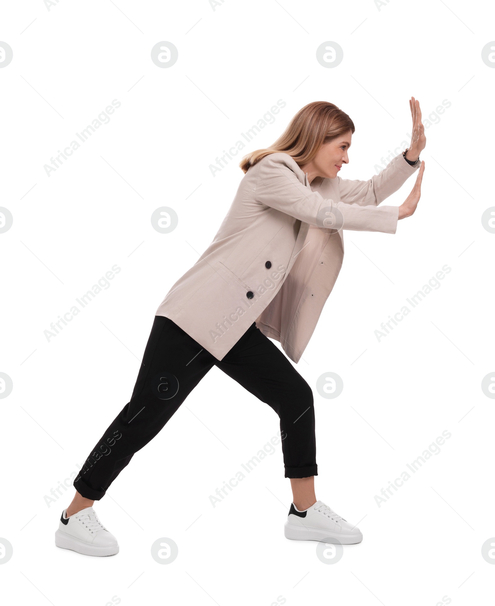 Photo of Beautiful businesswoman pushing something on white background