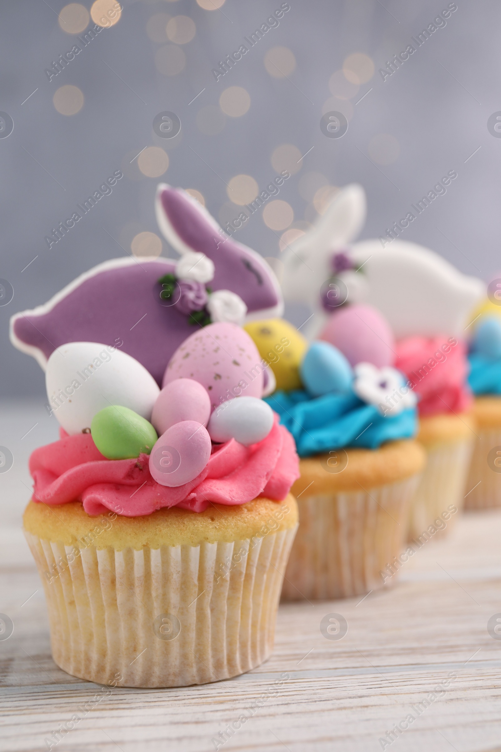 Photo of Tasty decorated Easter cupcakes on wooden table