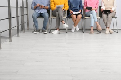 People waiting for job interview in office hall, closeup