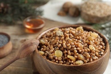 Photo of Traditional Christmas slavic dish kutia in bowl and spoon, closeup