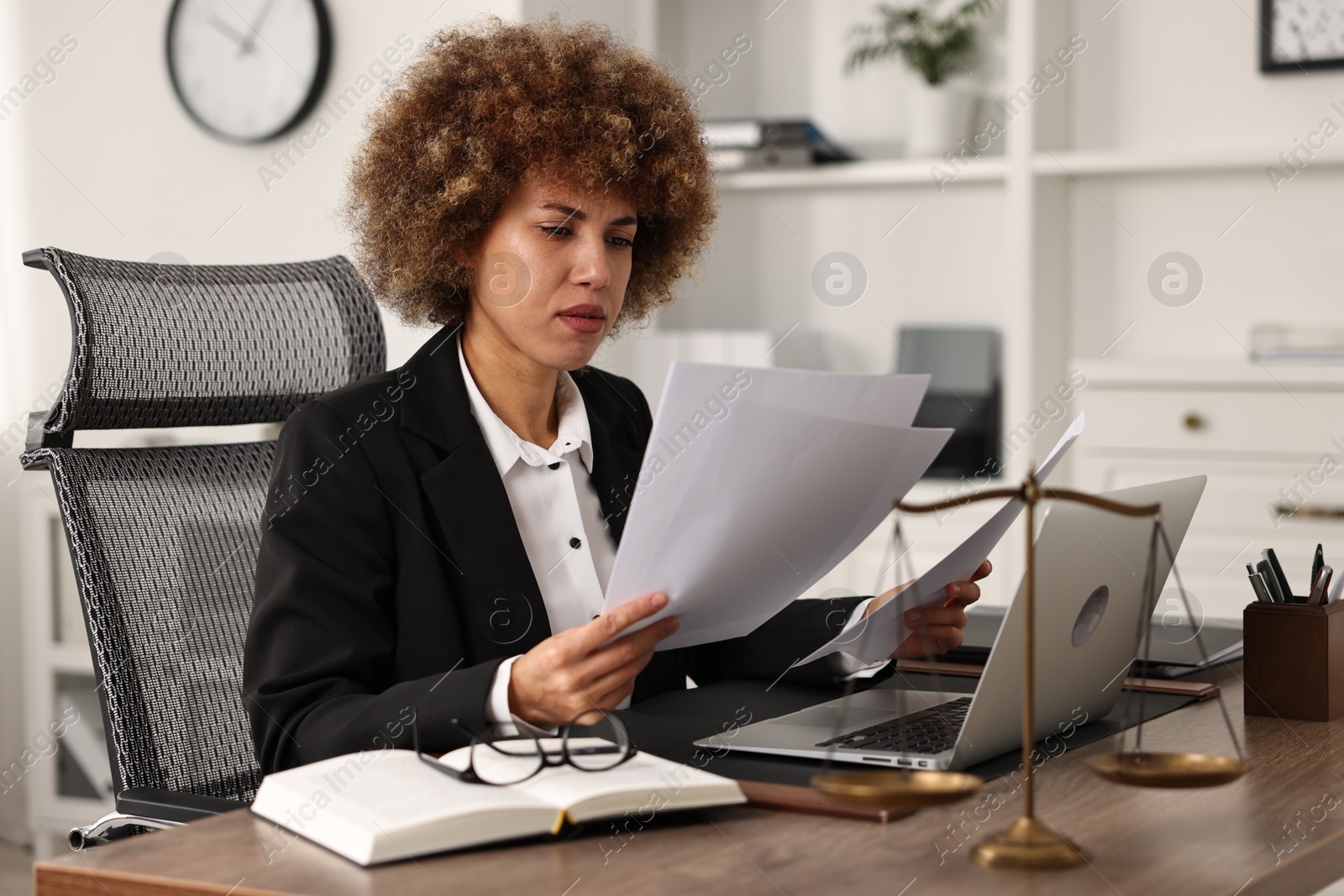 Photo of Notary working with documents at workplace in office