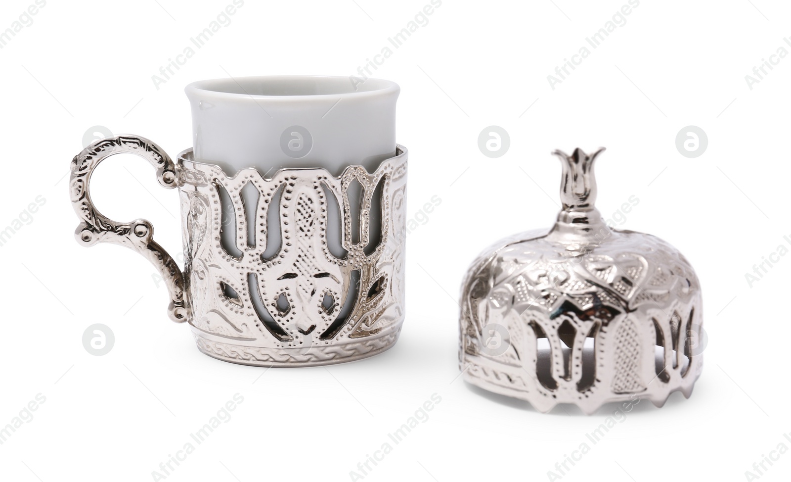 Photo of One ceramic cup in vintage holder and lid on white background