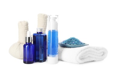 Photo of Spa composition. Bottles of cosmetic products, sea salt, towel and herbal bags isolated on white