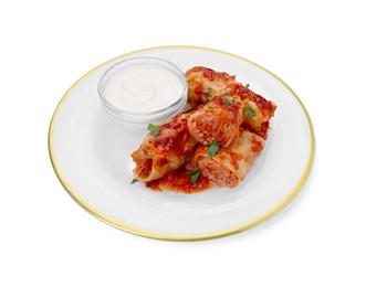Photo of Plate of delicious stuffed cabbage rolls with sour cream isolated on white