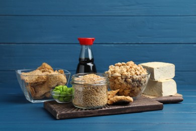 Photo of Different organic soy products on blue wooden table