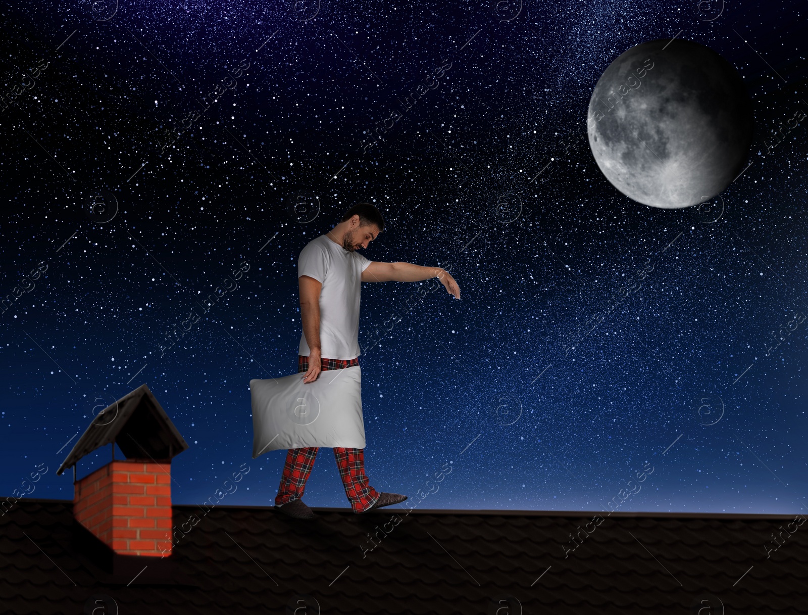 Image of Sleepwalker wearing pajamas with pillow on roof in night