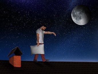 Image of Sleepwalker wearing pajamas with pillow on roof in night