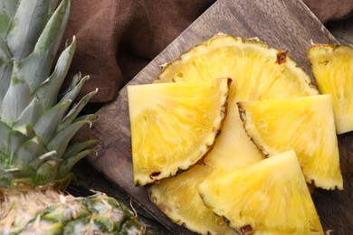 Pieces of tasty ripe pineapple on table, closeup