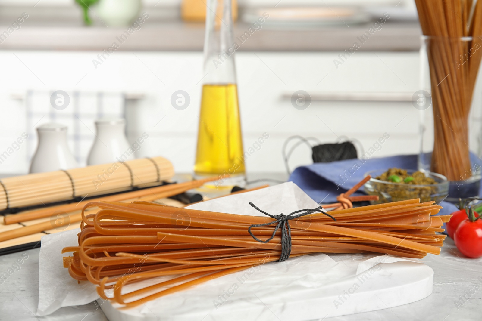 Photo of Tied uncooked buckwheat noodles on kitchen table