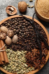 Photo of Different spices and nuts on gray table, flat lay