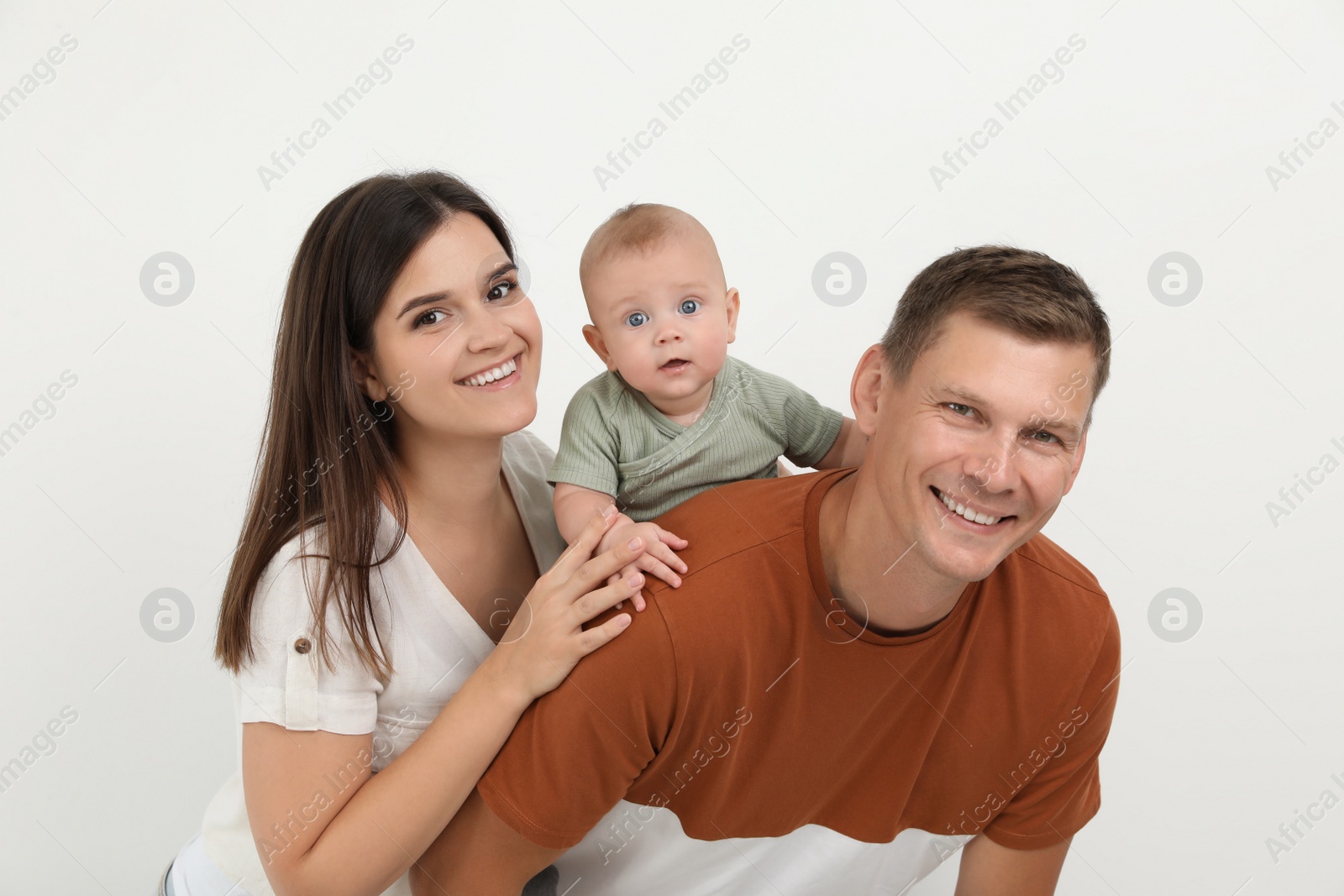 Photo of Portrait of happy family with their cute baby on white background