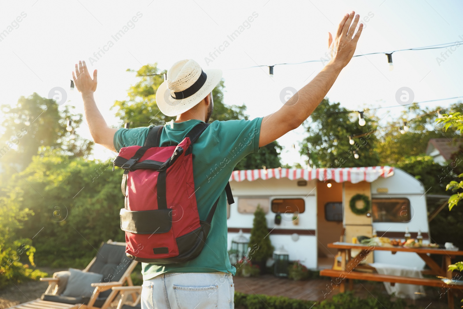 Photo of Young traveler with backpack outdoors. Summer trip