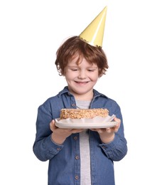 Birthday celebration. Cute little boy in party hat holding tasty cake on white background