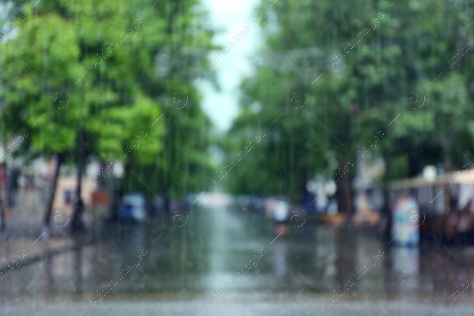 Photo of Blurred view of city street on rainy day