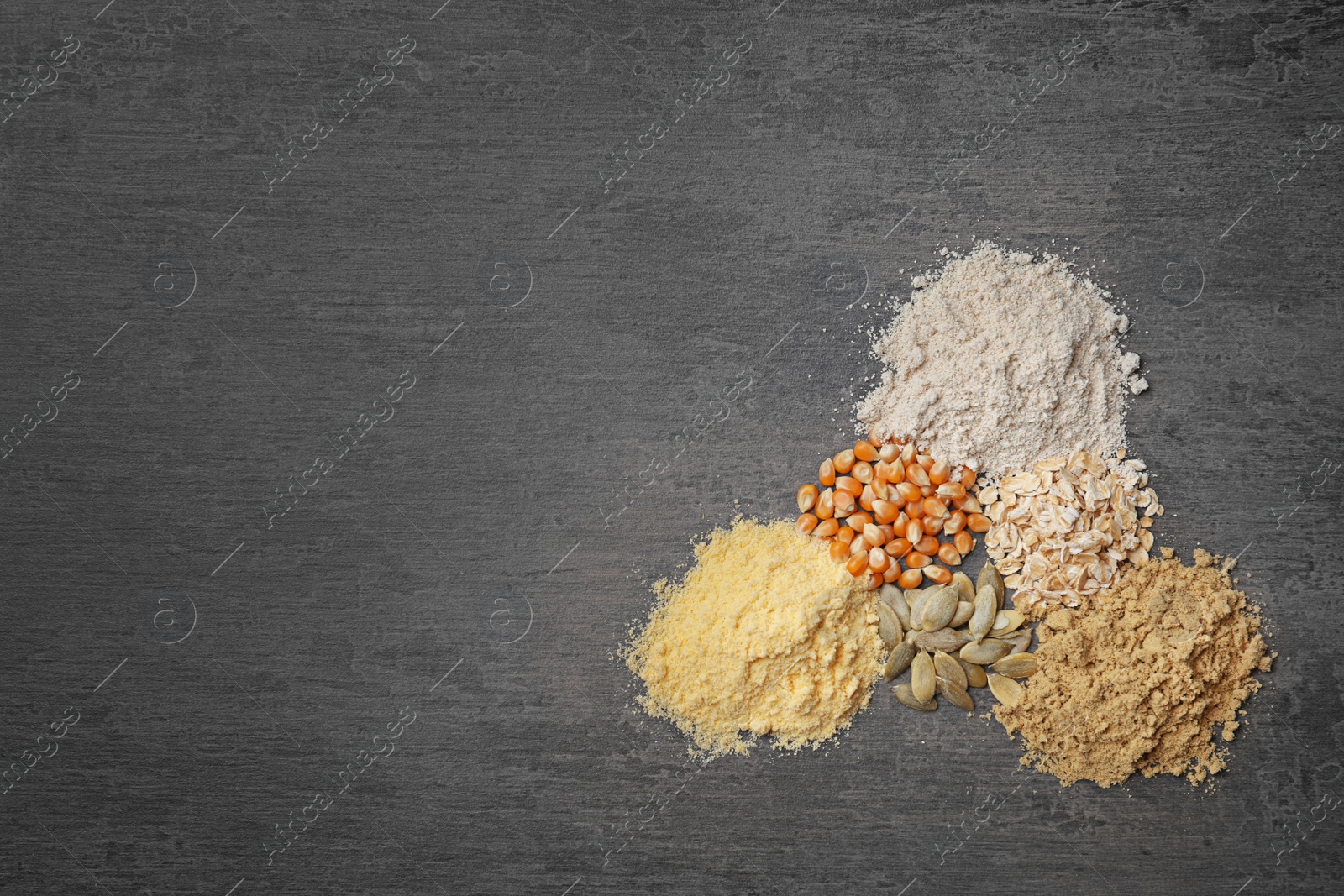 Photo of Composition with different types of flour on gray background