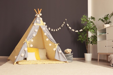 Cozy kids room interior with play tent and toys